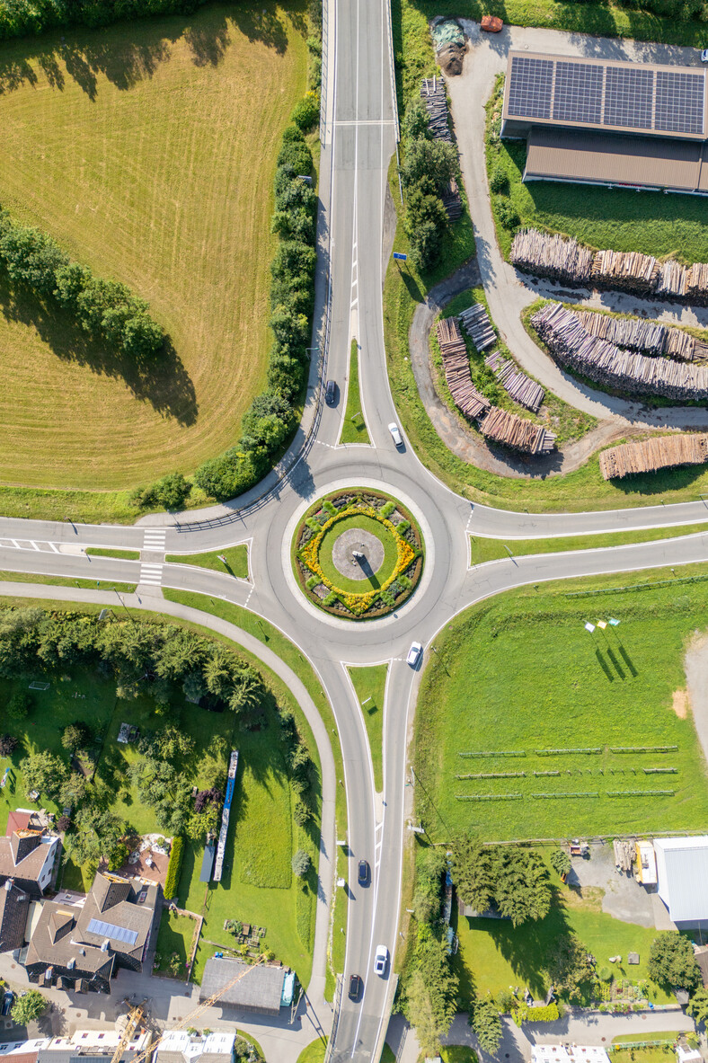 Aerial View of a Circular Roundabout in a Green Landscape