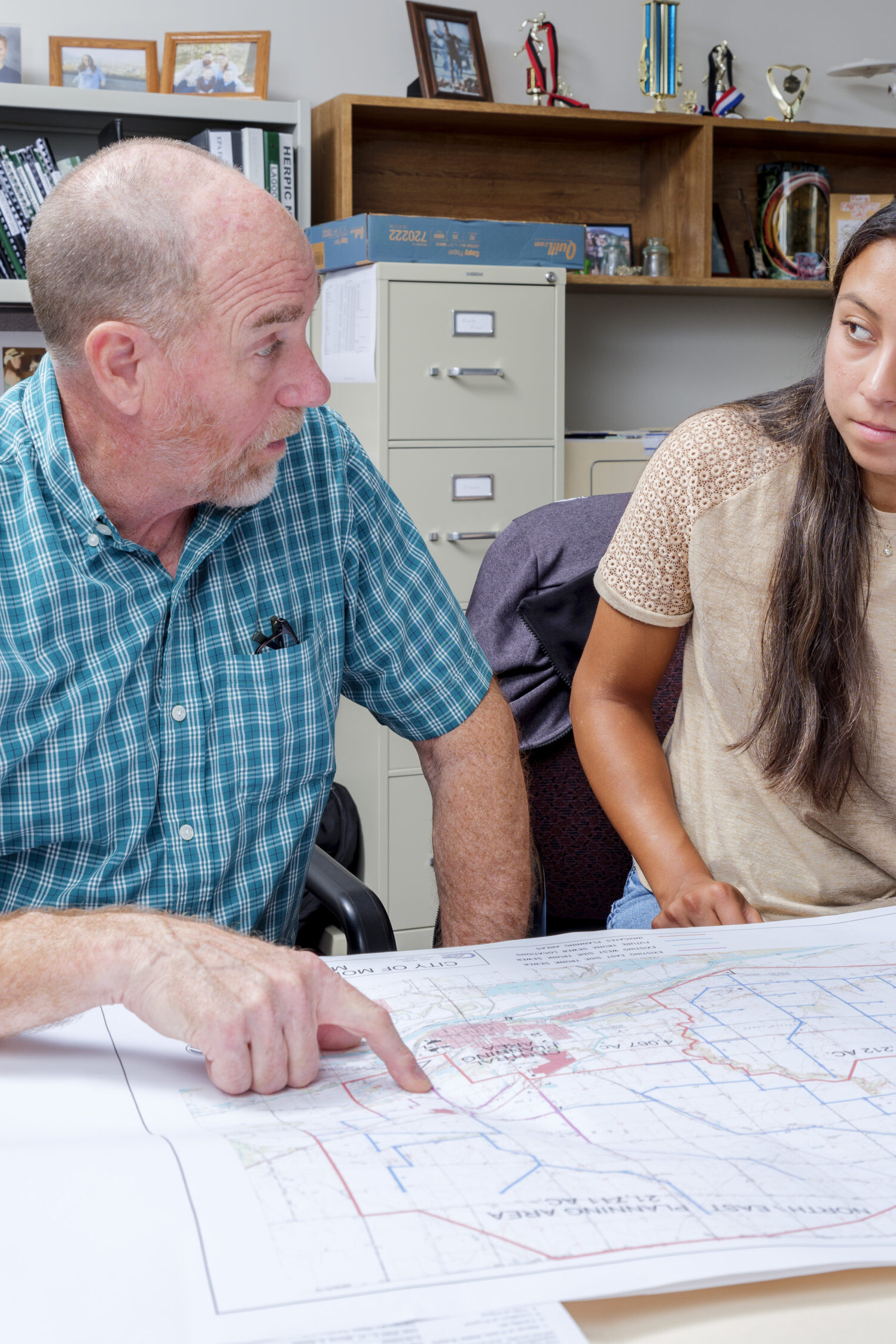 Man talking with co worker about construction plans