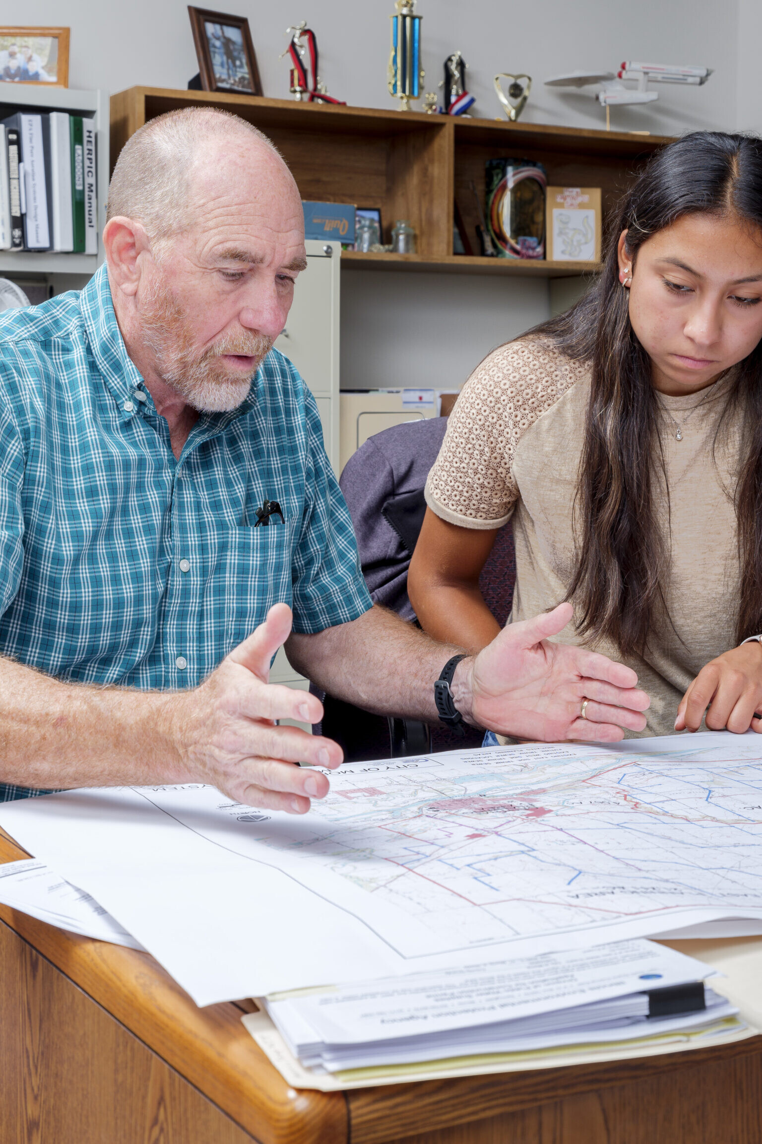 Man talking with co worker about construction plans